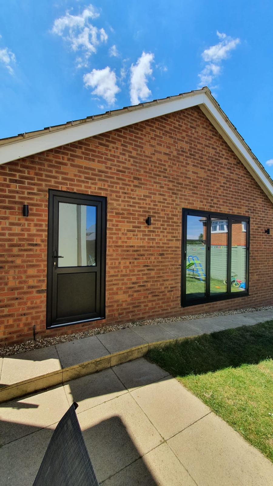 Brick exterior with a glazed door and large window